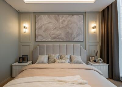 A modern, elegantly designed bedroom with contemporary lighting and a large framed wall art.