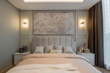 A modern, elegantly designed bedroom with contemporary lighting and a large framed wall art.