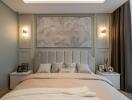 A modern, elegantly designed bedroom with contemporary lighting and a large framed wall art.