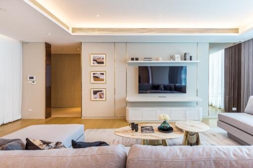 Spacious and modern living room with wall-mounted TV and stylish decor