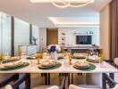 Modern dining room with a well-set table and a view into the living area