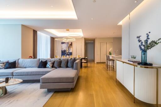 Spacious and modern living room with wooden flooring and contemporary furniture.