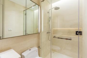 Modern bathroom with glass shower enclosure and large mirror