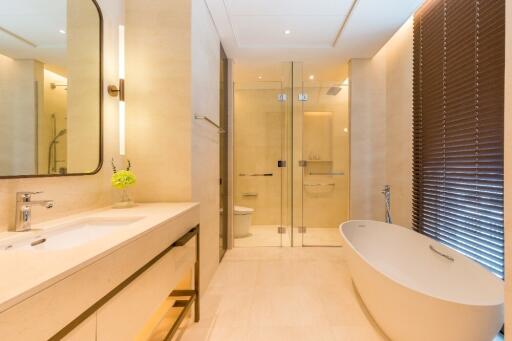 Modern bathroom with bathtub, shower, and large mirror