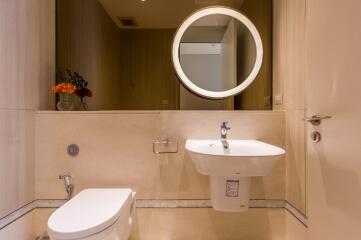 Modern bathroom with mirror, sink, and toilet