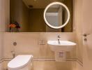 Modern bathroom with mirror, sink, and toilet