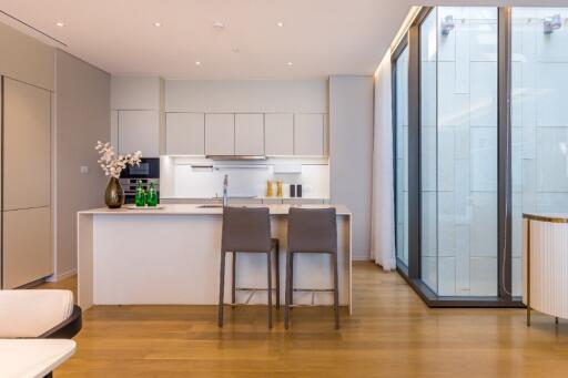 Modern kitchen with island and adjacent windows