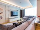 Modern luxurious living room with large sectional sofa and wall-mounted TV