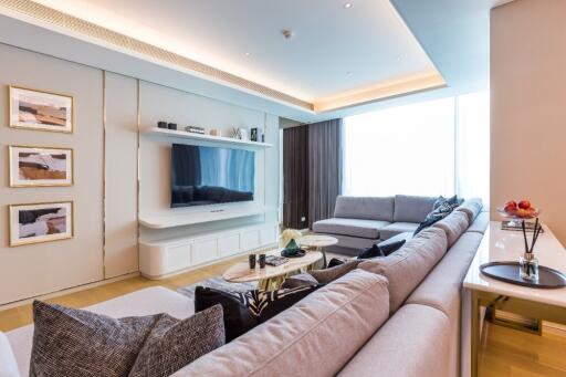 Modern luxurious living room with large sectional sofa and wall-mounted TV