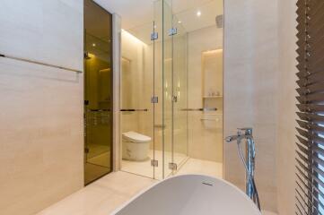 Modern bathroom with glass-enclosed shower and bathtub