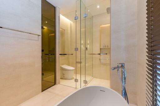 Modern bathroom with glass-enclosed shower and bathtub