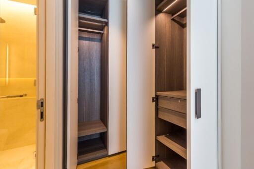 Well-lit closet with multiple shelves and drawers