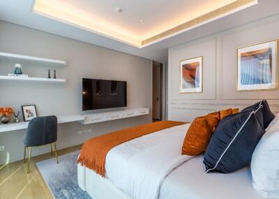 Modern bedroom with wall-mounted TV and decorative elements