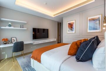 Modern bedroom with wall-mounted TV and decorative elements