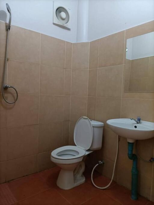 Bathroom with toilet, sink, and shower