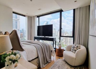 Modern bedroom with a large window and city view