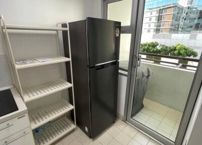 Modern kitchen with large refrigerator and balcony access