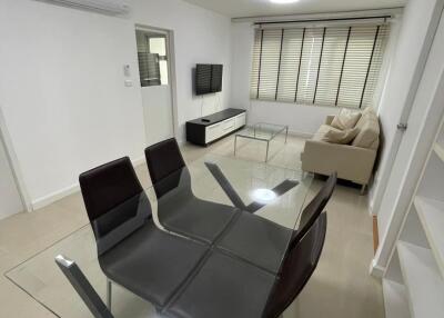 Modern living room with glass dining table and sofa