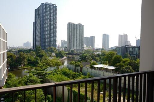 Balcony with a view of high-rise buildings and greenery