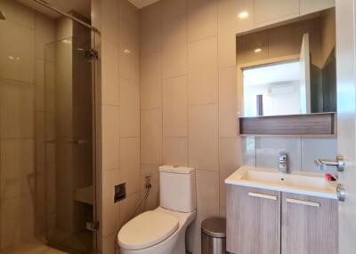 Modern bathroom with shower, toilet, and sink