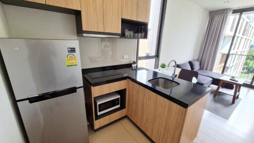 Modern kitchen area with adjacent living space