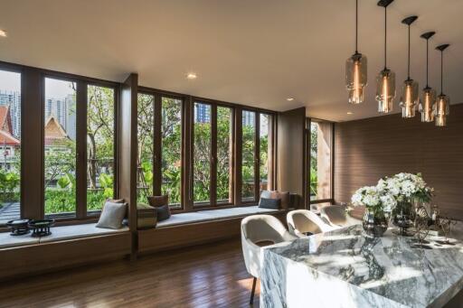 Spacious living room with large windows and modern lighting