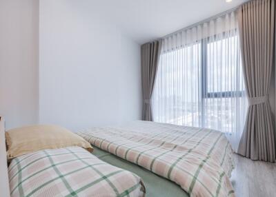 Bedroom with large window and curtains