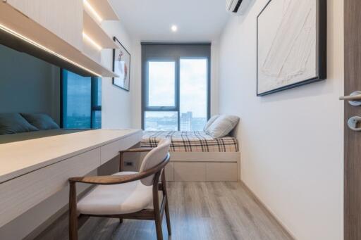 Modern bedroom with desk and large window