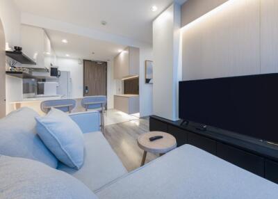 Modern living area with sofa and wall-mounted TV