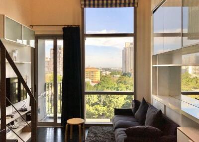 Modern living room with a large window and a view of the city