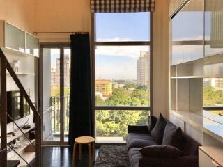 Modern living room with a large window and a view of the city