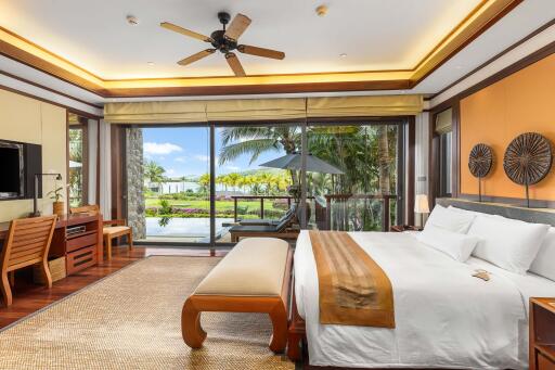 Spacious bedroom with king-size bed and balcony view