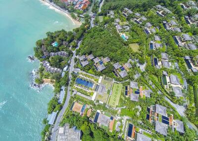 Aerial view of a hillside property complex overlooking the ocean