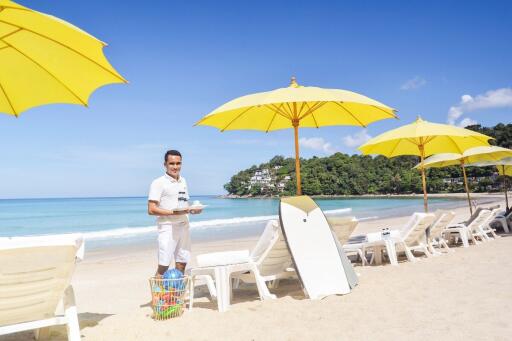 Sunny beach with yellow umbrellas and lounge chairs