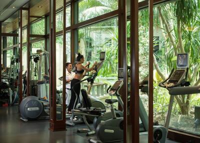 Modern fitness center with cardio equipment and outdoor views