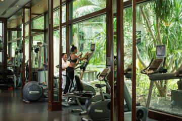 Modern fitness center with cardio equipment and outdoor views