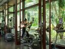 Modern fitness center with cardio equipment and outdoor views