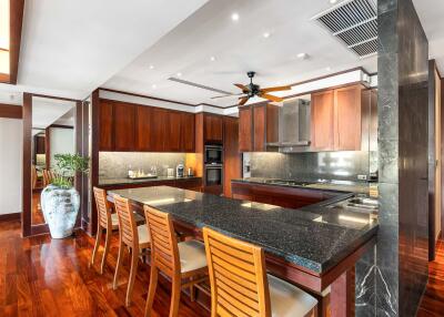 Spacious modern kitchen with wooden cabinets and island seating