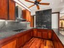 Modern kitchen with wooden cabinetry and dark granite countertops