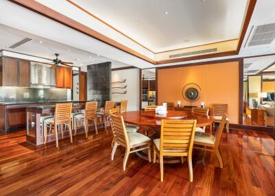 Spacious dining area with wooden furniture and polished hardwood floors