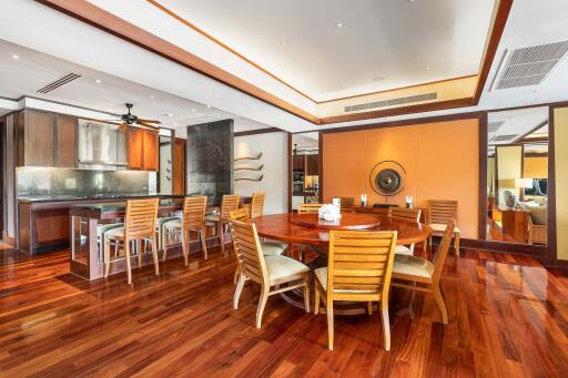 Spacious dining area with wooden furniture and polished hardwood floors