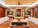 Luxury spa room with wooden flooring, massage tables, and ambient lighting