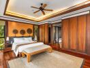 Spacious bedroom with wooden floors, large bed, and ceiling fan