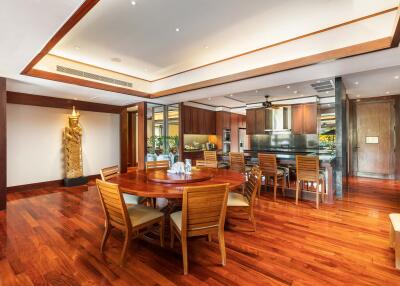 Spacious dining area with wooden flooring and furniture