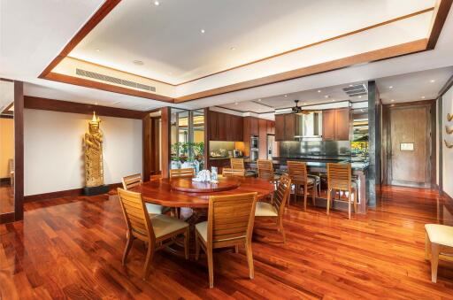 Spacious dining area with wooden flooring and furniture