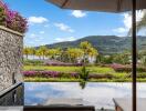 Picturesque view of lush garden and hills with a pool