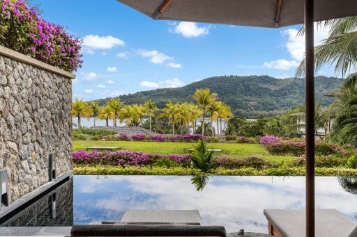 Picturesque view of lush garden and hills with a pool