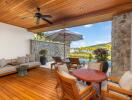 Spacious outdoor patio with seating area, wooden flooring, and garden view.