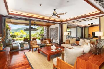 Spacious living room with large sliding glass doors leading to a terrace with scenic outdoor views