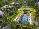 Aerial view of a luxury residential complex with swimming pool and surrounding greenery